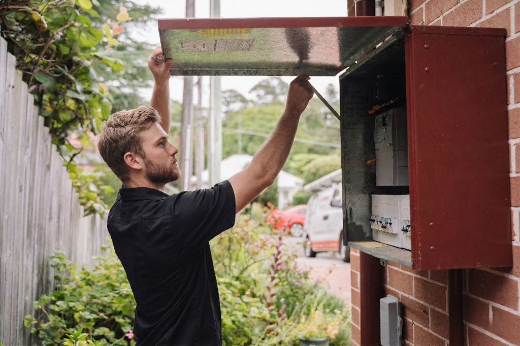 Electrician installing downlights in a Gymea home